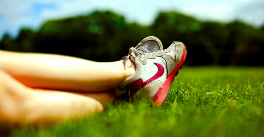 a person in a grassy field with grass and trees