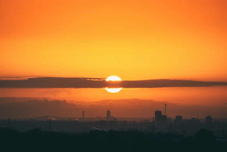 sun setting behind the clouds in the evening