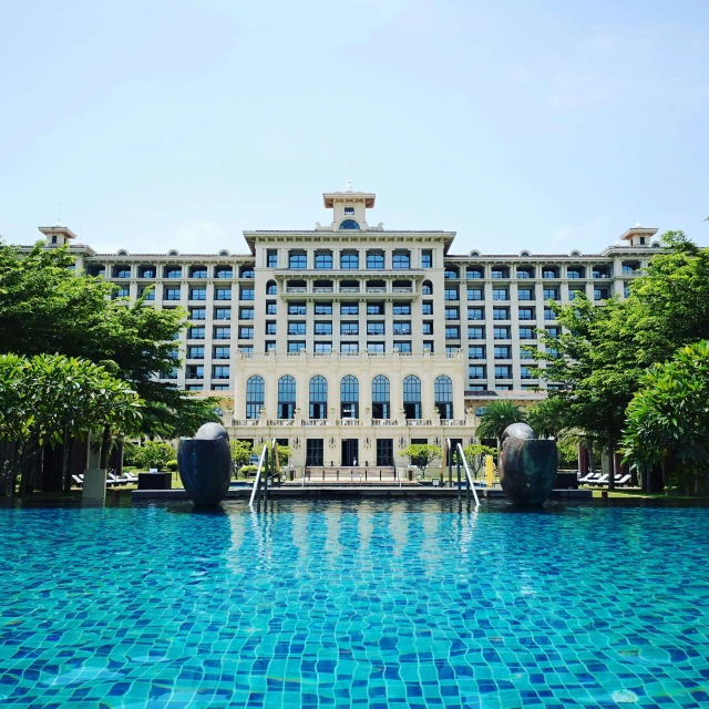 a big building sitting above a large pool