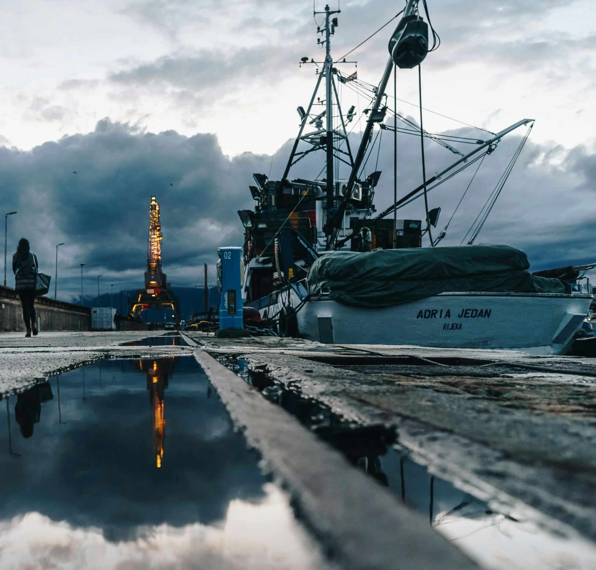 a boat docked with several other ships in the water