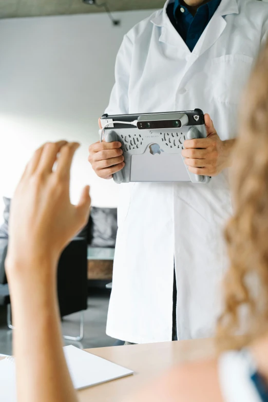 a female medical professional is holding a clip board with an empty folder