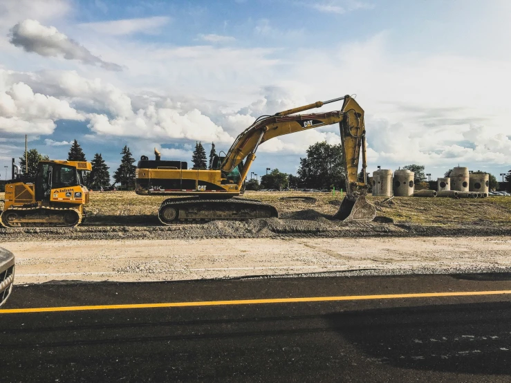 some bulldozers are sitting next to a building