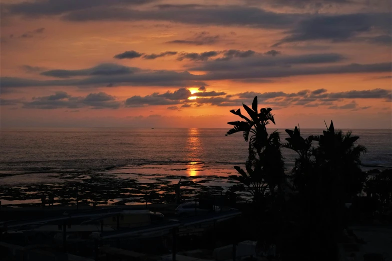 the sun is setting over the ocean with the horizon visible