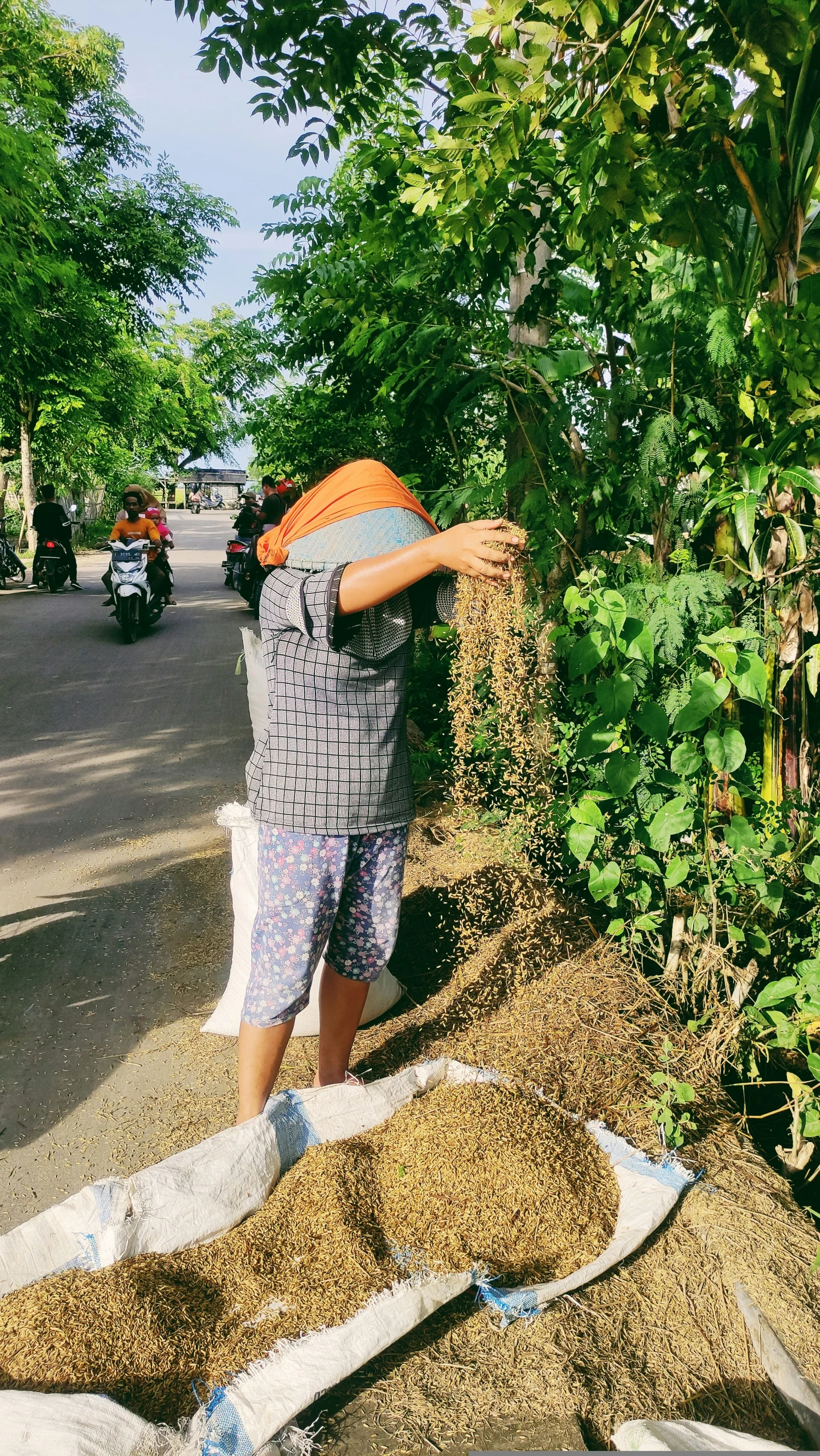 a man standing next to bags of dirt