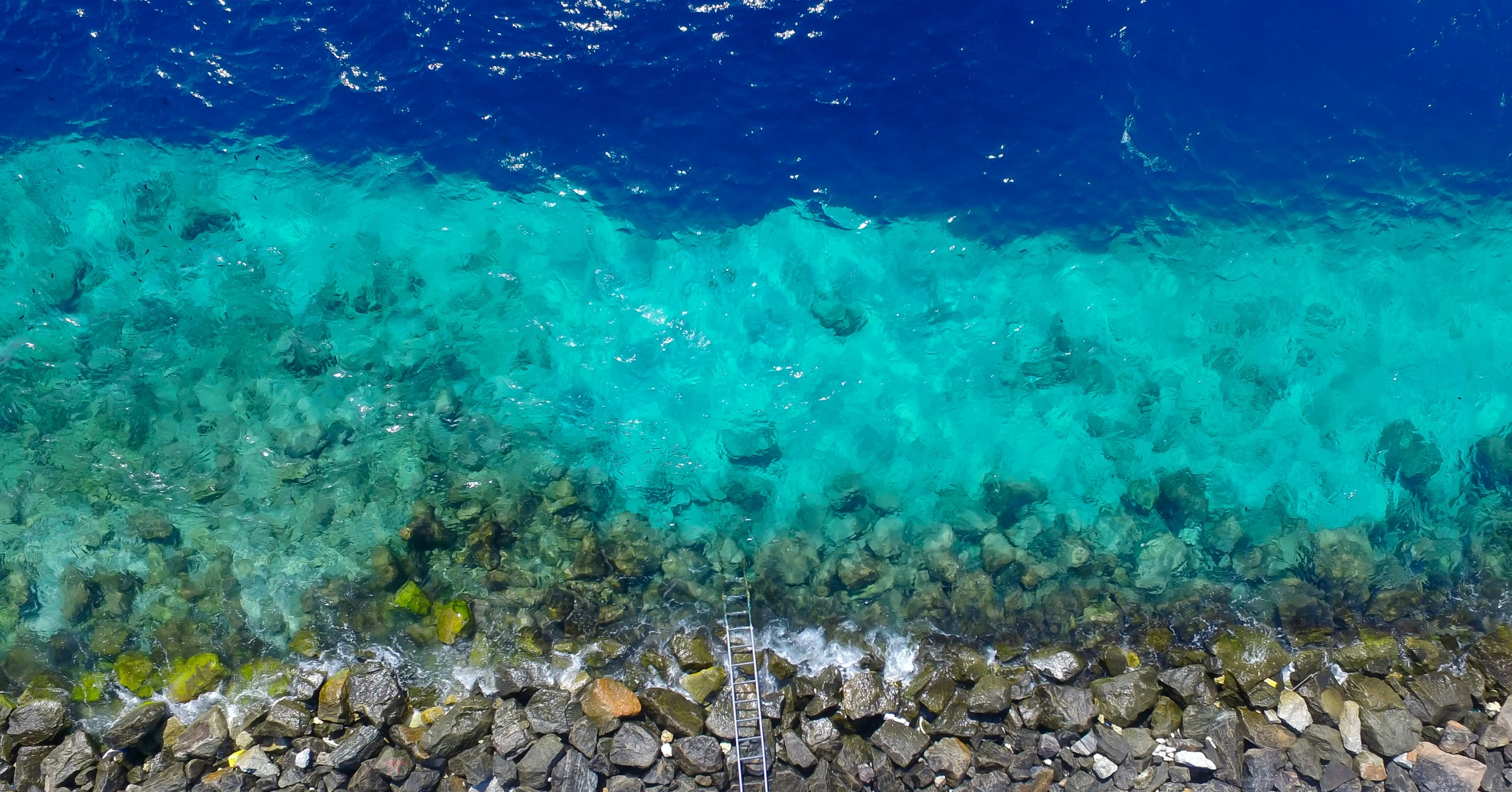 the ocean and rocks have water that looks like they are floating down