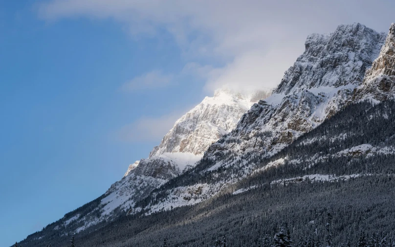 the view of some snow covered mountains from a moving boat