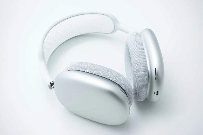 the white, closed earphones are resting on the surface