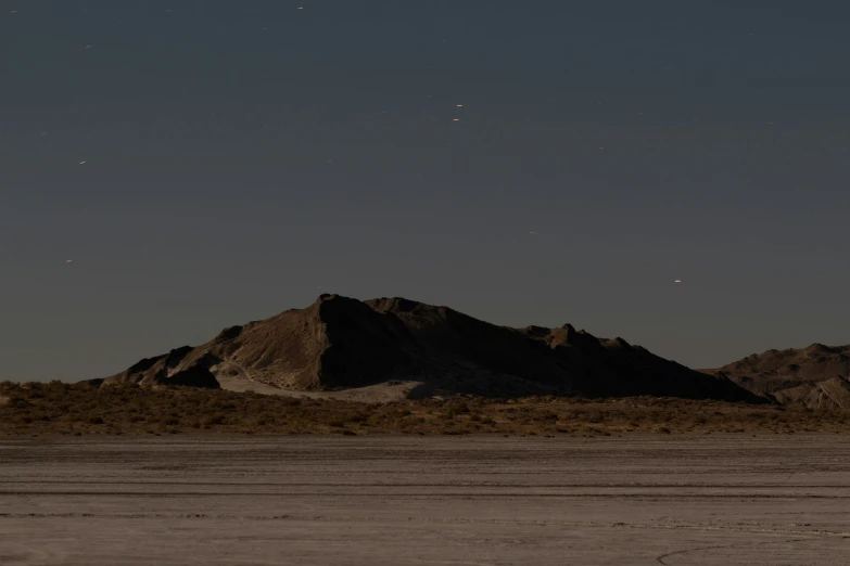 a mountain range with a small star on a clear night