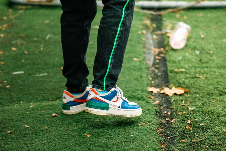 a person standing in the grass on the lawn with a tennis racket