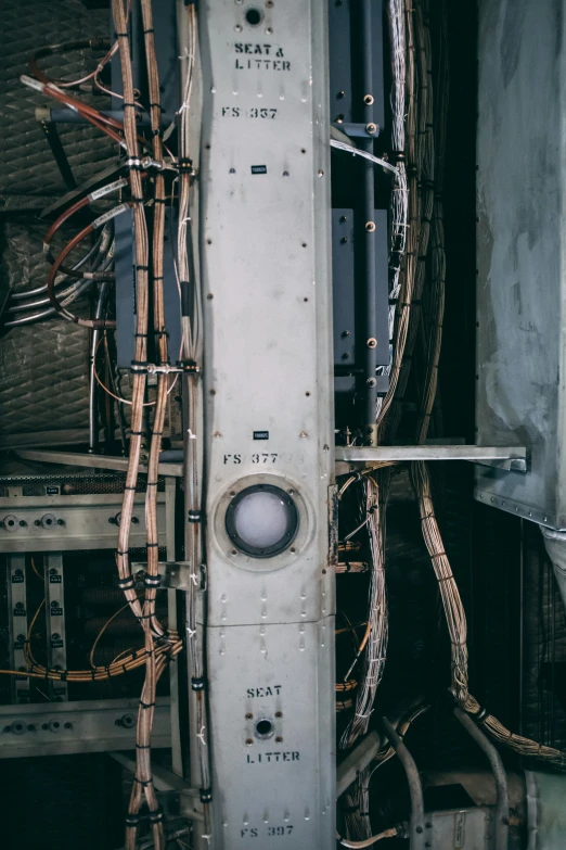 the back side of a white door that has many wires and electrical cords