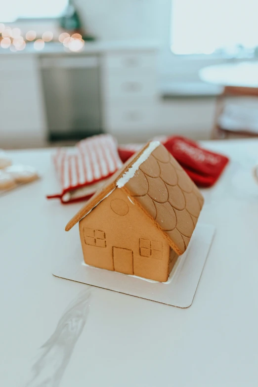 a wooden model house on a white table