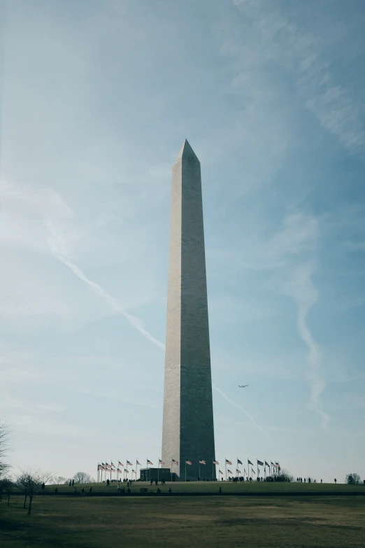 a tall monument is shown against a blue sky