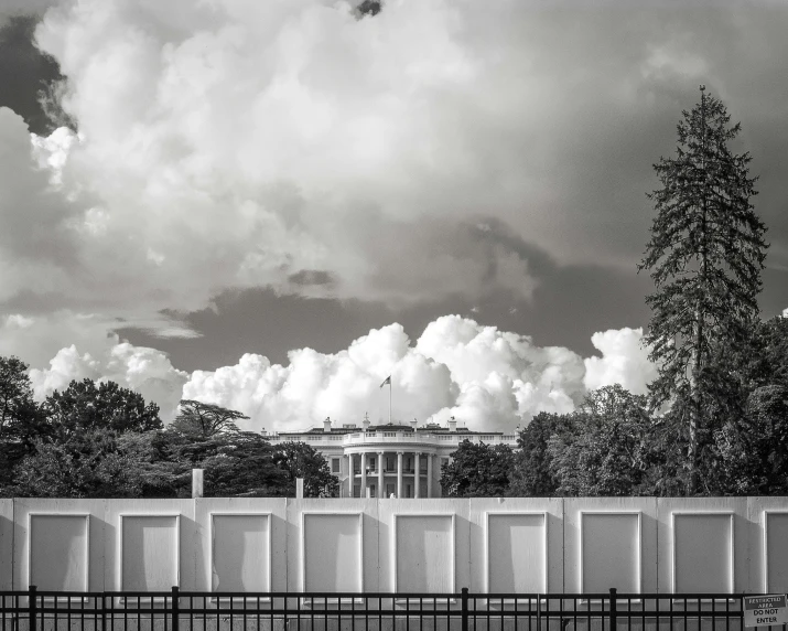 a white building and trees in black and white