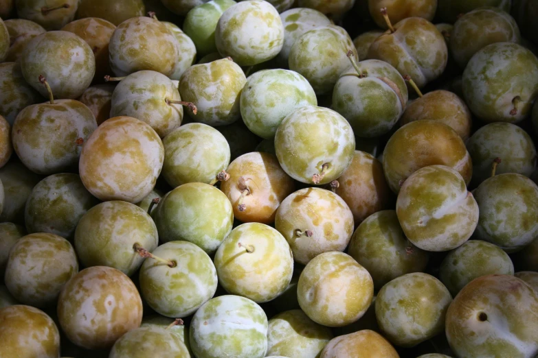 green apples and yellow apples sit in a pile