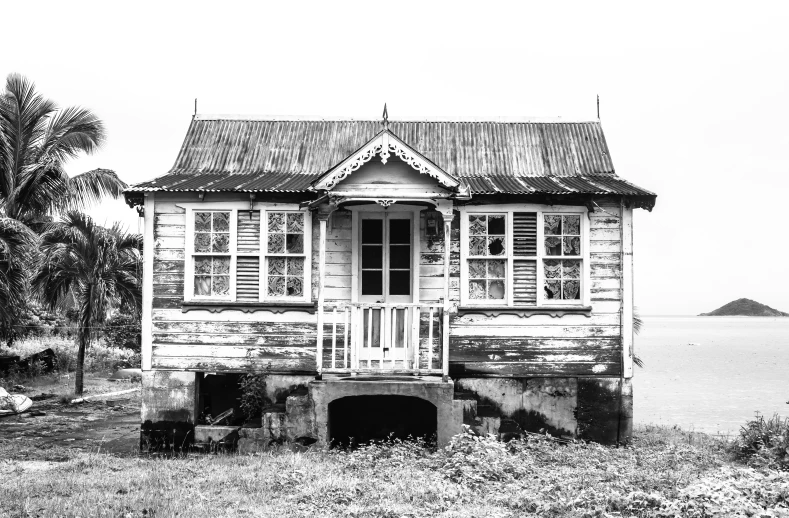 a black and white po of a house in the grass