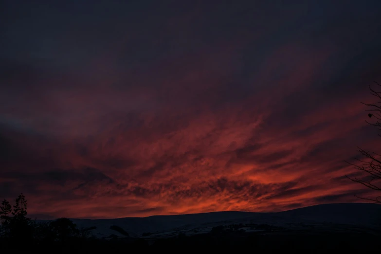 a red sky with clouds in the sky