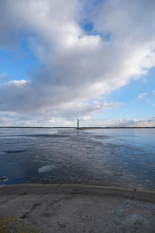 the sky and some clouds above the water