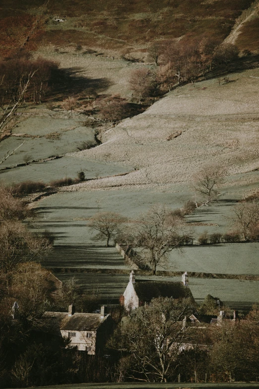 a countryside scene of a house and mountains