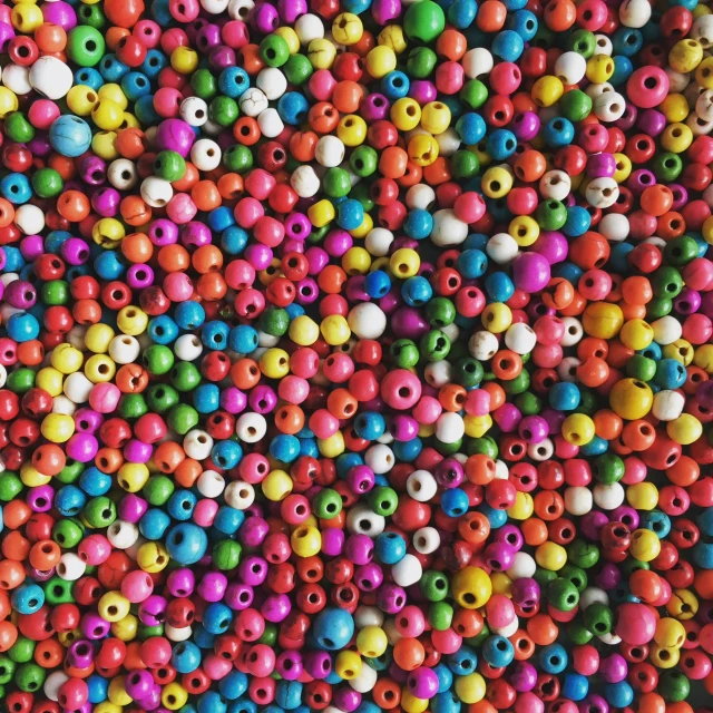 colorful beads are scattered on top of each other