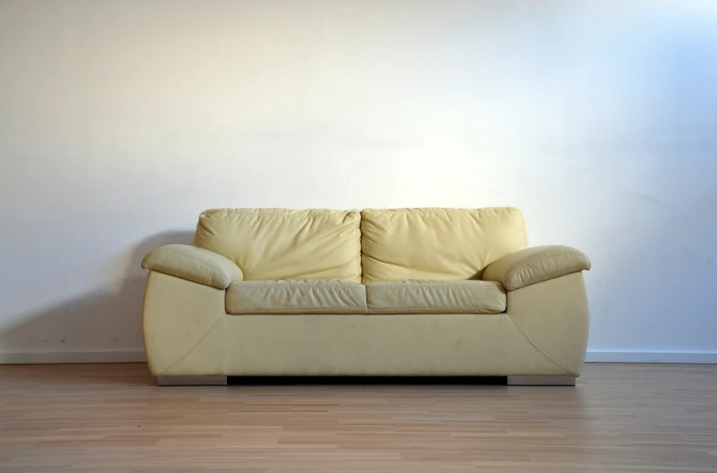 this couch is sitting on the hardwood floor