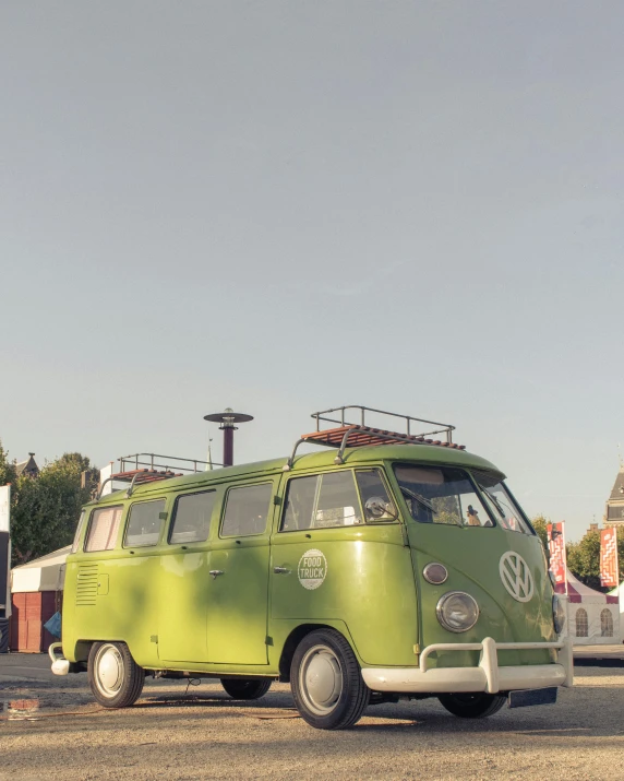 the camper van is green and has white wheels