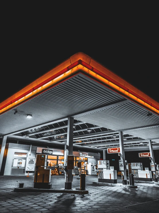 a gas station with the lights on in the dark