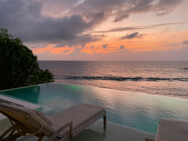 a view of an ocean and sky from a pool