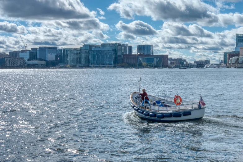 a blue and white boat sailing in the water