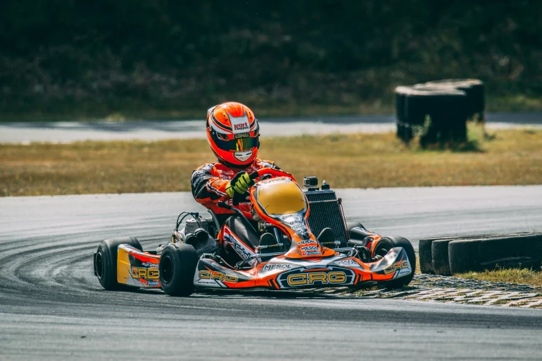 a man is driving a go kart around a track
