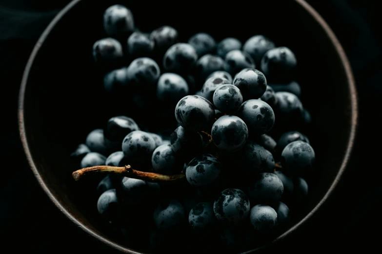 a large brown bowl full of blueberries