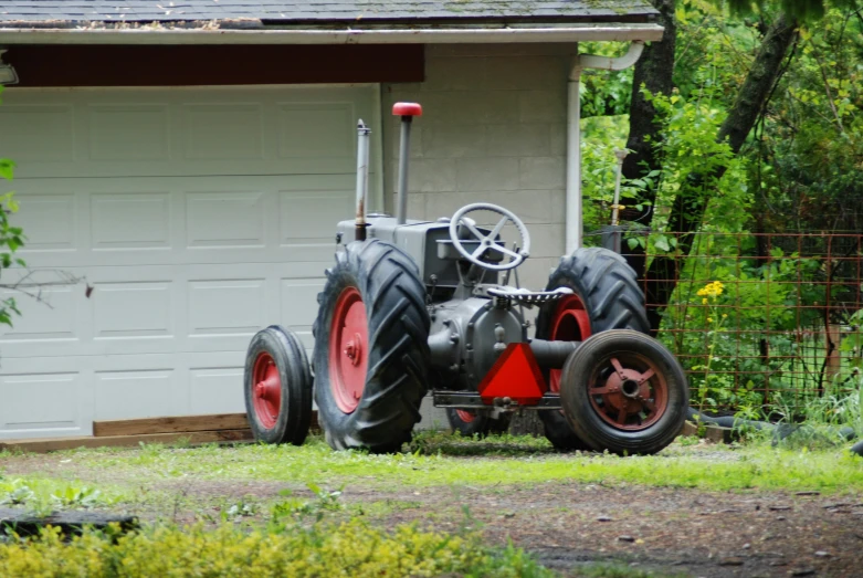 a red tractor that is parked outside the building