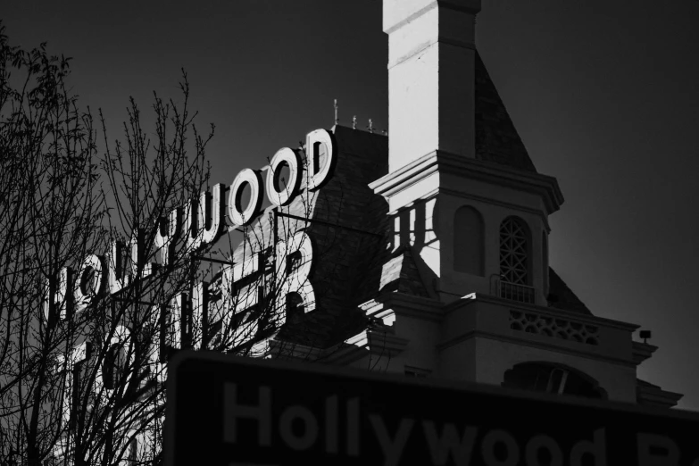 the hollywood sign at night with the clock tower in the background