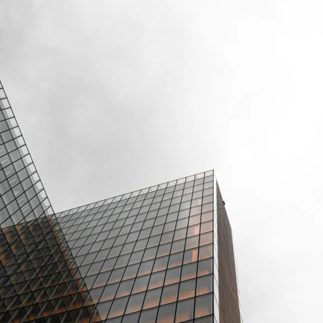 a tall building with lots of windows next to a skyscr