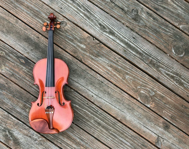 violin lying on top of wooden board and in the air