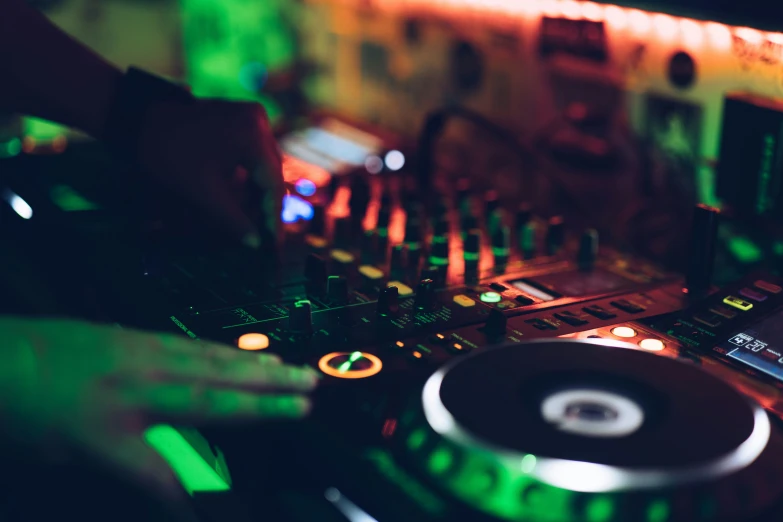 a dj mixing music with hands touching the decks