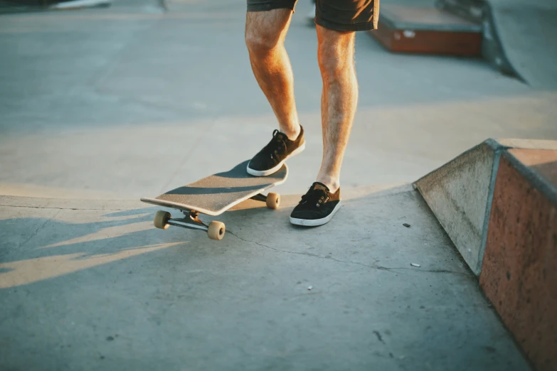 a skateboarder standing on top of a skateboard ramp