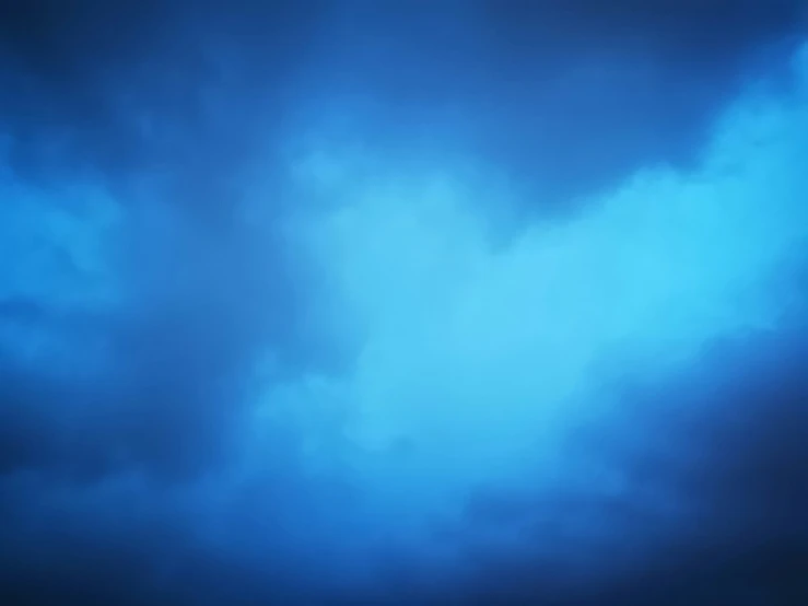 a plane in flight above dark blue clouds