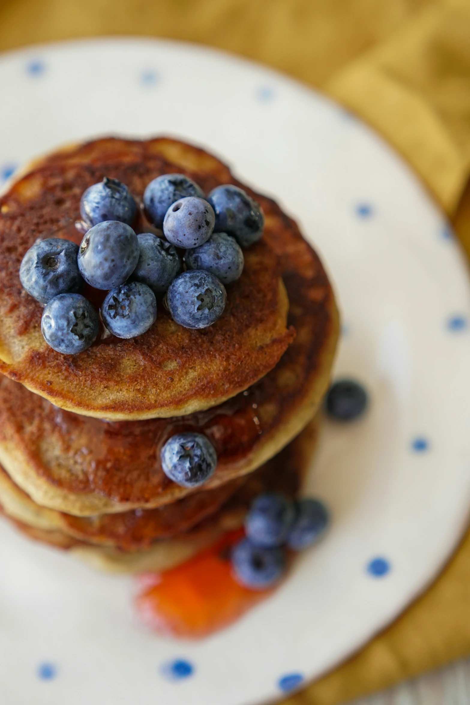 some pancakes have blueberries on top of them