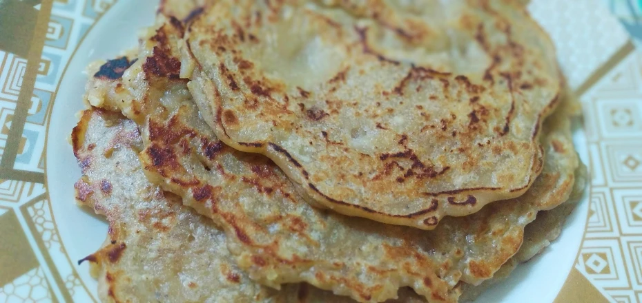 pancakes on a plate are piled high up