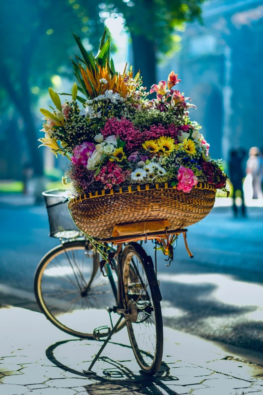 a bicycle loaded with flowers and greenery on a city street