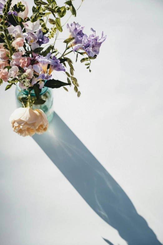 a bouquet of colorful flowers sitting in a vase on the table