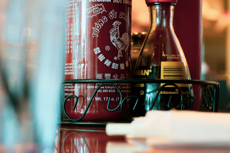 a glass table with some bottles and cups on it