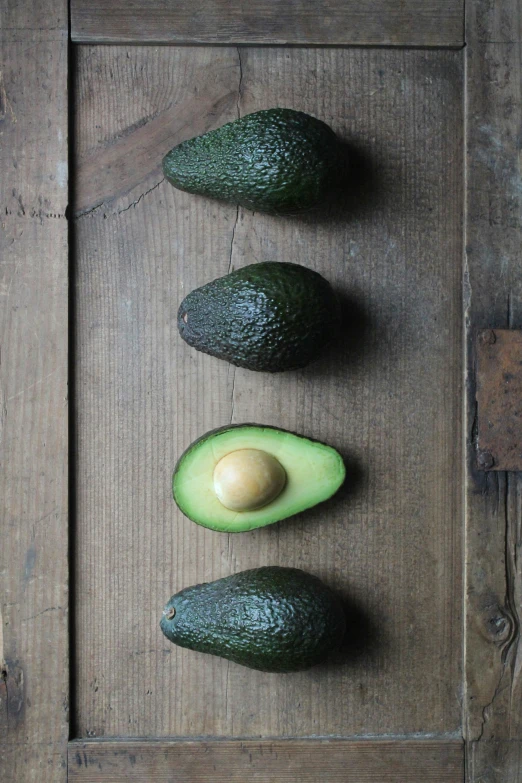 a piece of bread is laying on the floor next to avocados