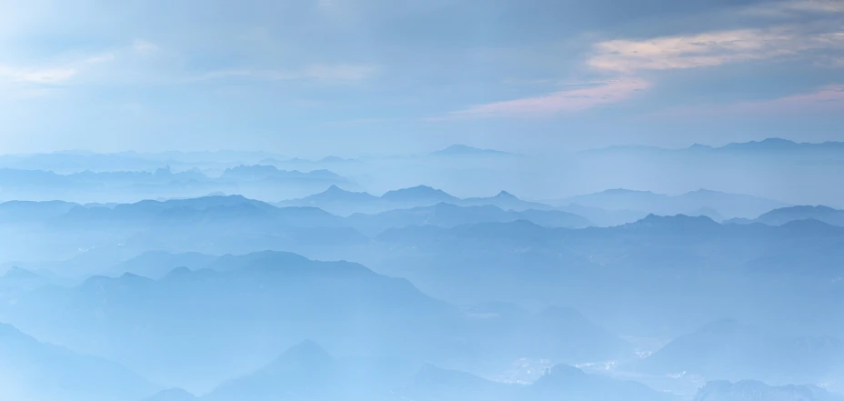 some blue mountains are shown with very low clouds