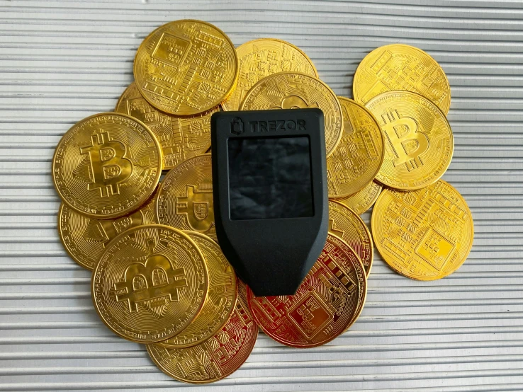 a computer surrounded by many gold coins