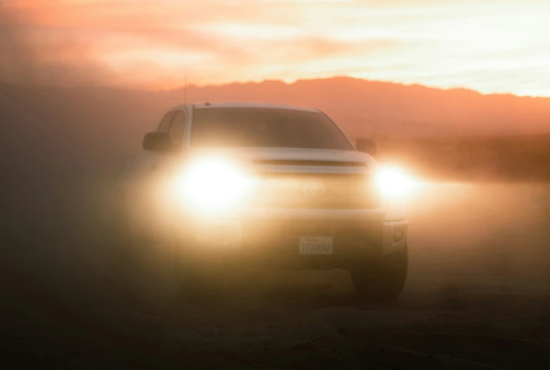 the front end of a car is shown on a foggy road