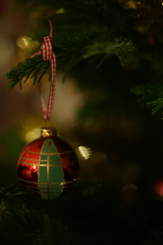 an ornament hangs from the tree's christmas decoration