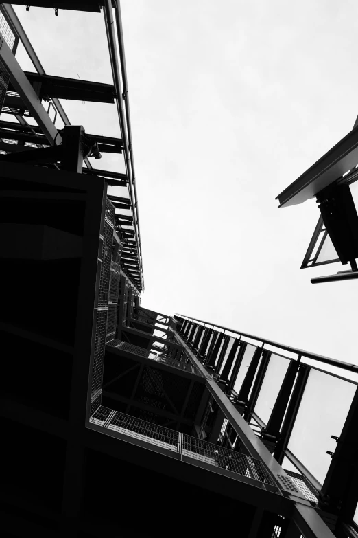 a person on a skateboard in the air between buildings