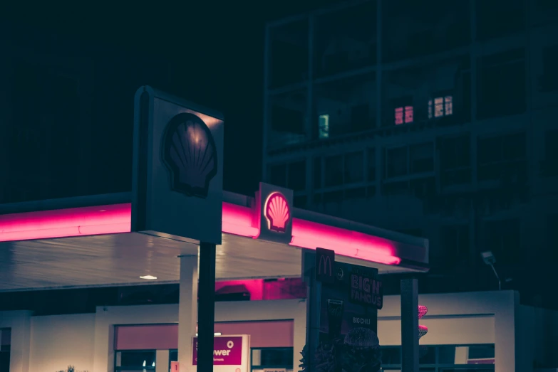 an empty gas station is lit up at night