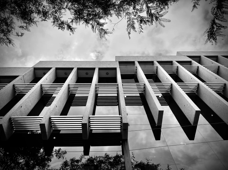 a tall building with a lot of windows and benches